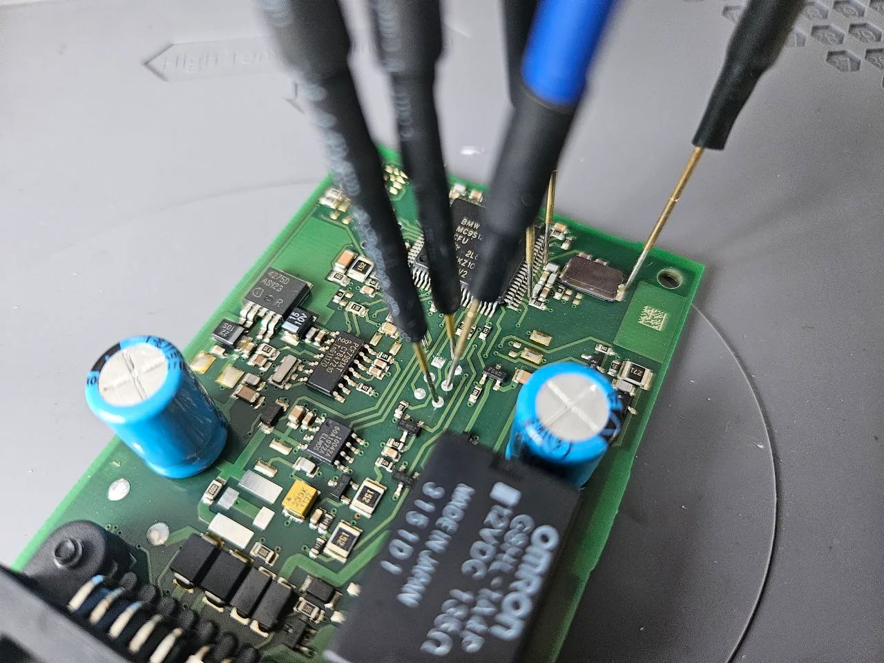 Close-up of a BMW module connected to the bench programming equipment