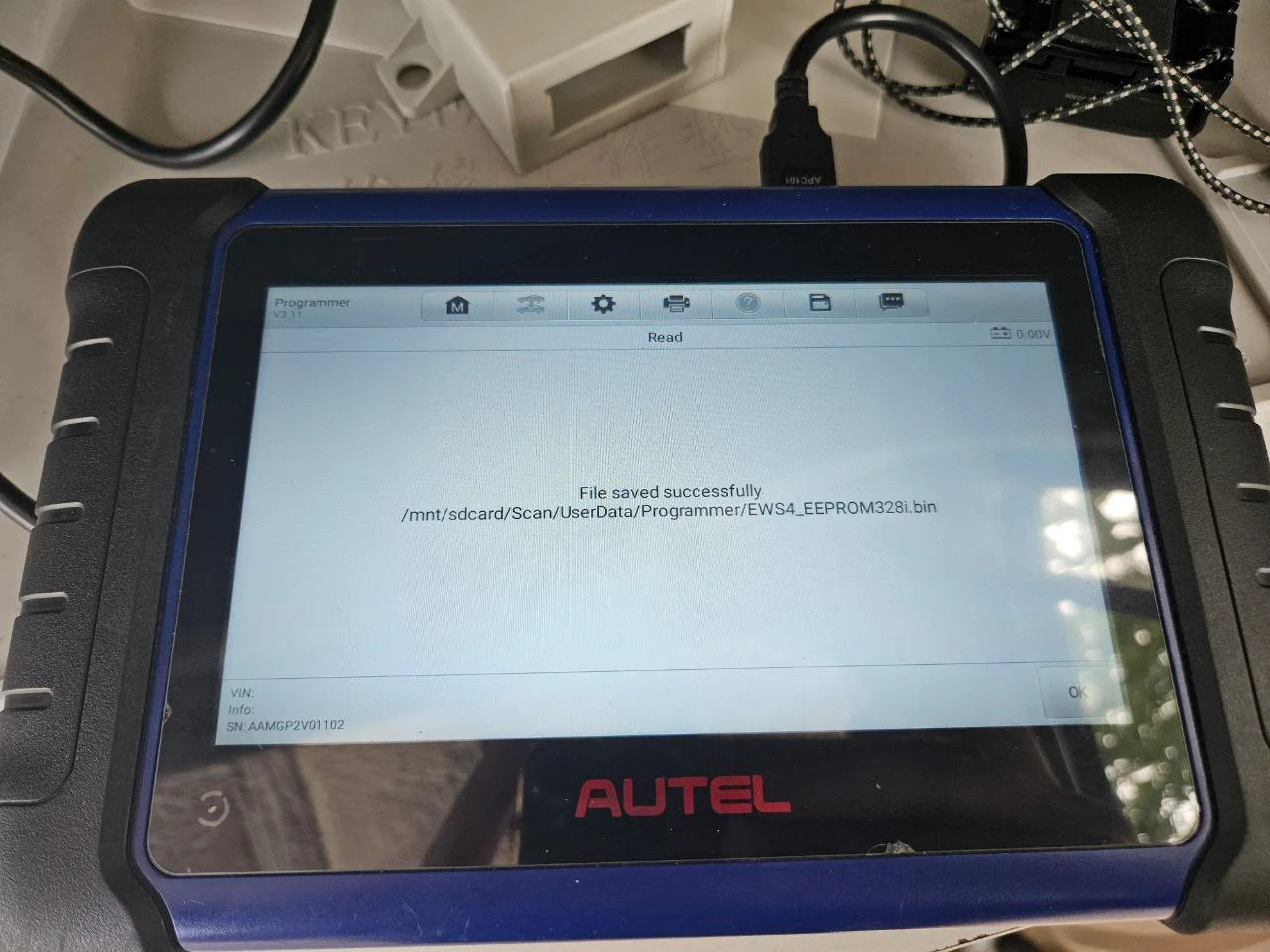Autel programmer showing a file-save confirmation during BMW electronic module work